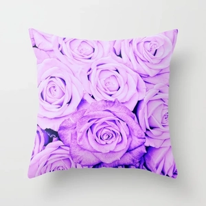 Close-up of square cushion cover with purple rose floral pattern and smooth fabric