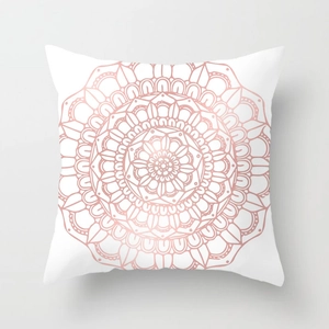 Detail view of square white cushion cover featuring metallic rose gold mandala pattern