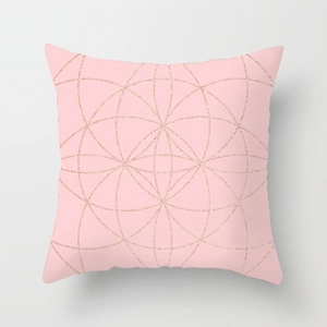 Detail of pink throw pillow case featuring geometric rose gold glitter circle patterns