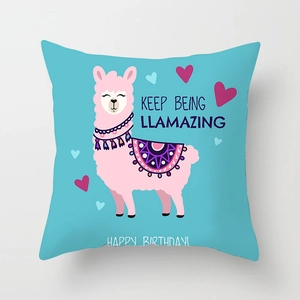 Detail of teal alpaca cushion cover with Keep Being Llamazing birthday text print