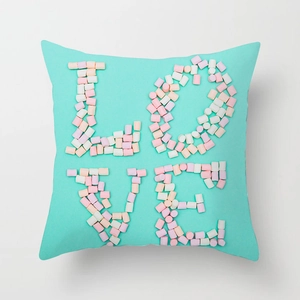 Close-up of turquoise cushion cover featuring sweet pink 3D LOVE letter collage design