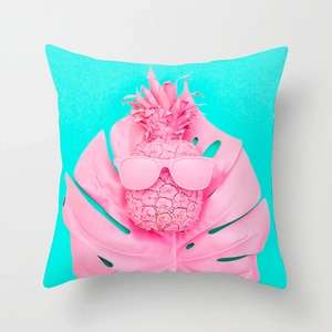 Detail of pink pineapple and monstera leaf print on a square velvet pillowcase
