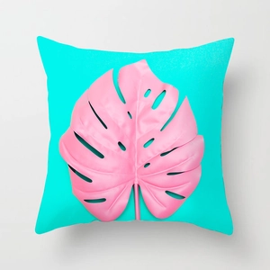 Detail view of tropical pink monstera leaf pattern on square teal pillow cover fabric