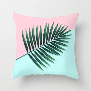 Detail of pink and blue tropical palm leaf cushion cover with soft fabric texture