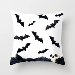 Close-up of Halloween pillowcase with black bats and skull print on white fabric