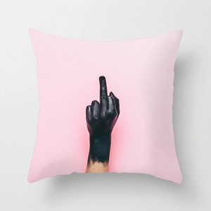 Detail of pink Nordic cushion cover featuring a bold black middle finger graphic print