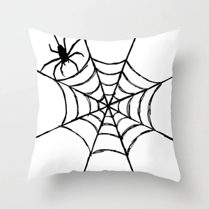 Close-up of Halloween pillowcase featuring black spider and web print on white fabric