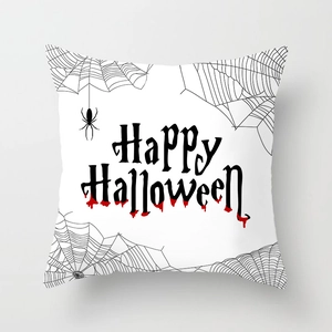 Detail of Halloween pillowcase featuring black spider web and bloody text on white fabric