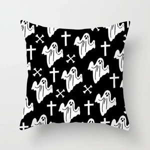 Close-up of Halloween pillowcase featuring hand-drawn white ghost and cross patterns