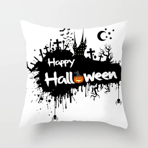 Detail of Halloween pillowcase with black castle, bats, and orange pumpkin on white fabric