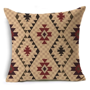 Close-up of geometric Aztec pattern linen pillowcase featuring red and brown diamond motifs