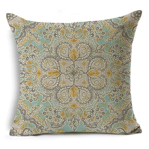 Close-up of geometric mandala pattern on square linen cushion cover with blue and gold tones