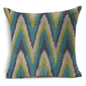 Detail of geometric zigzag pillow case with textured linen fabric in teal and yellow