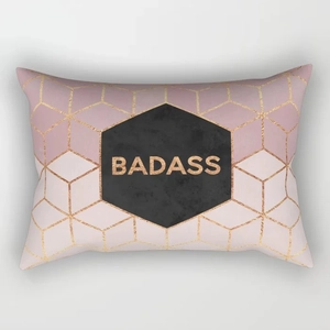 Detailansicht eines rosa geometrischen Kissenbezugs mit goldenem Muster und Badass-Schrift