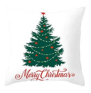 Close-up of white Christmas pillow cover with green tree design and Merry Christmas text