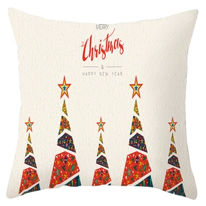 Detail of Christmas pillowcase with ethnic tree patterns and festive holiday text