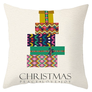 Detail of Christmas pillow cover with stacked gift boxes and festive holiday text