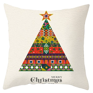 Close-up of geometric Christmas tree print on festive peach skin pillowcase