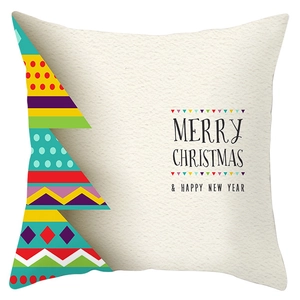 Detailed close-up of Christmas tree pattern and holiday greetings on festive pillowcase