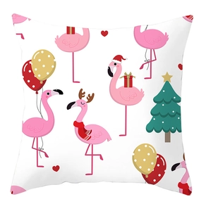 Detail of flamingo Christmas throw pillow cover with festive hat and scarf patterns
