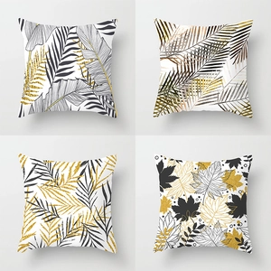 Set of 4 geometric plant leaf throw pillow covers in black, white, and metallic gold finish
