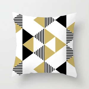 Detail of modern geometric peach skin pillowcase with gold and black triangles