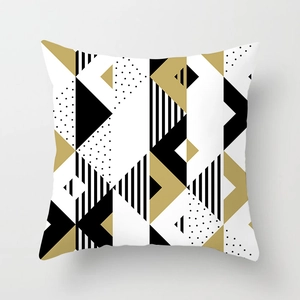 Detail of peach skin fabric cushion cover with modern geometric black and gold patterns