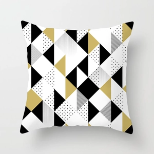 Macro shot of geometric peach skin pillowcase with black and gold abstract patterns