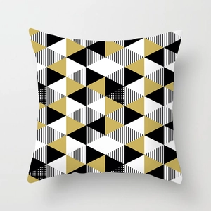 Detail of modern geometric pillowcase with gold, black and white triangle pattern texture