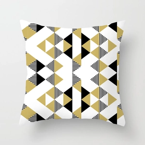 Detailed view of modern geometric peach skin pillowcase with black and gold triangles