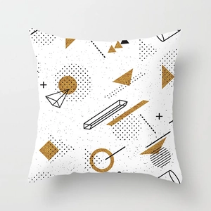 Detailed view of modern geometric pattern on a peach skin pillowcase with gold and black shapes