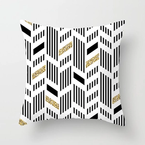 Detail of modern geometric pillowcase with black white stripes and golden glitter texture
