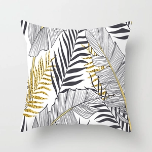 Detail of tropical leaf print on peach skin pillowcase with gold glitter veins