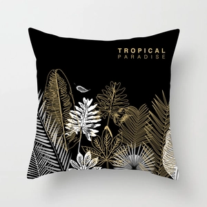 Detail of black peach skin pillowcase with gold and white tropical leaf pattern design