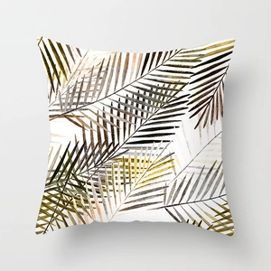 Detail of square peach skin pillowcase with earth-toned palm leaf patterns on white
