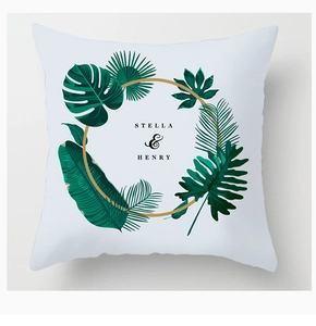 Detail of Nordic style pillow cover featuring tropical leaves and gold ring accents