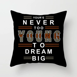 Detail of black pillowcase with white geometric text pattern Your're Never Too Young To Dream Big
