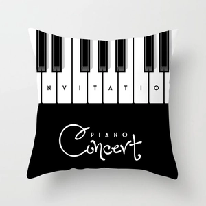 Detailed view of the piano concert cushion cover featuring black and white keys on fabric