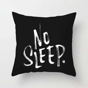 Detail of minimalist black pillow case featuring white hand-painted NO SLEEP text art