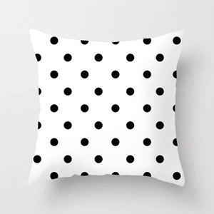 Detailed close-up of a modern square pillowcase featuring black polka dots on white fabric