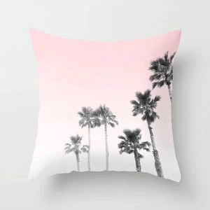 Détail de la housse de coussin rose avec motifs de silhouettes de palmiers noirs