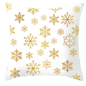 Close-up of golden snowflake patterns printed on white peach skin fabric cushion cover