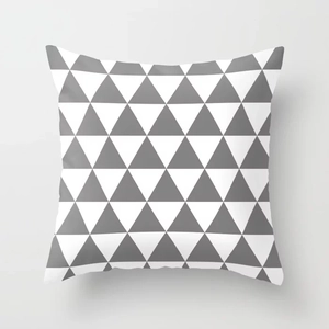 Detailed macro view of gray and white geometric triangle patterns on soft peach skin fabric