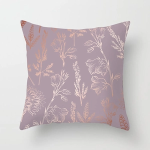 Detailed close-up of rose gold floral patterns on a lilac pink peach skin velvet pillow cover