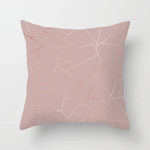 Detailed close-up of rose gold geometric pattern on pink peach skin fabric cushion cover
