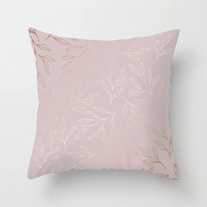 Close-up of peach skin pillowcase featuring rose gold metallic leaf pattern