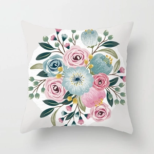 Close-up of fresh floral cushion cover featuring pink and blue roses on white fabric