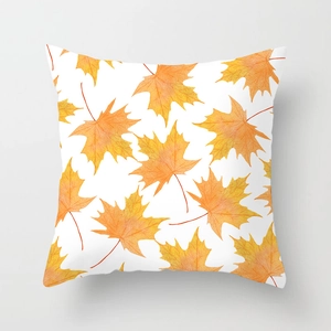 Close-up of fall maple leaf cushion cover with vibrant watercolor prints and fine texture