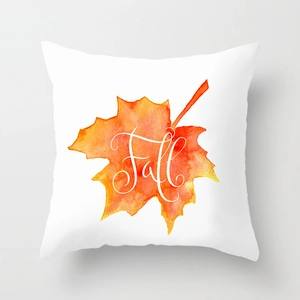 Detail of white square pillowcase with orange watercolor maple leaf and Fall text
