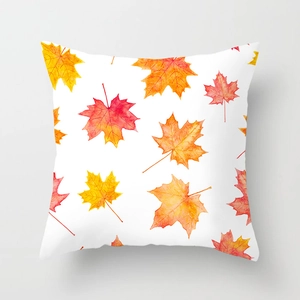Detailed close-up of square pillowcase with red and gold watercolor autumn maple leaves